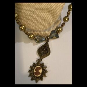 Beautiful, gold and crystal pink cameo.